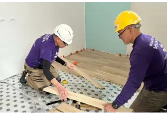Malcolm laying floors during a house renovation