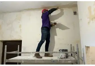 Nik tries his hand at plastering