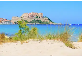 An arc of fine sand overlooked by Calvi's 12th century citadel