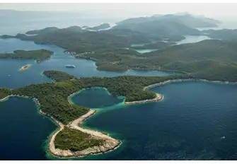 The twin saltwater lakes of Mali Jezero and Veliko Jezero, top right in this shot, are surrounded by ancient pine forests criss-crossed with hiking and biking trails
