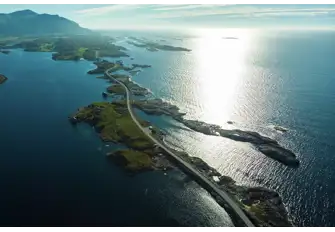 The famous Atlantic Road, as featured in 007 movie No Time To Die, skips from skerry to skerry to link Kårvåg on the island of Averøya to Vevang on the mainland