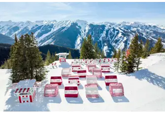 Join Burgess at the an iconic red and white striped cabana on the snow