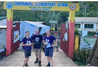 Burgess is so proud of Julie, Andrew and Marie (l-r) for taking up the challenge to help build a school in the Philippines