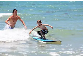 Encourage your older children in mastering a new fun skill from surfing to diving 
