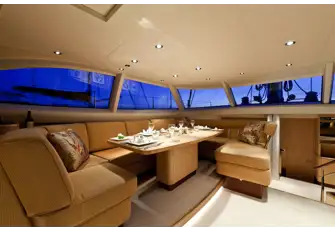 Dining in the raised saloon, opposite seating and the nav station with the main saloon down the steps forward
