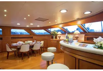 A corridor to starboard leads past the raised pilothouse to the bar and dining area forward
