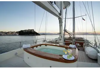 Looking forward on the flybridge, from a swathe of sunpads around the jacuzzi, the sun lounge forward of the mizzen and the helm station