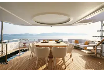 Open air dining with bar and wine fridge on hand makes a perfect entertainment space