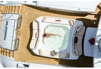 The jacuzzi has a bench seat aft and open-air dining forward
