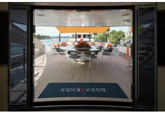 Shaded open-air dining and a sun lounge on the upper deck aft