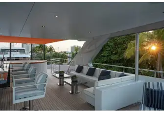 Looking aft on the sun deck across the sit-up wet bar, lounge and jacuzzi