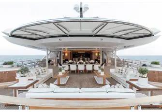 Open-air dining and lounging space on the upper deck aft