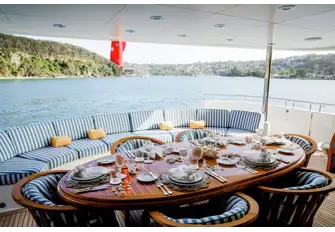 Open-air dining and sun lounging on the main deck aft