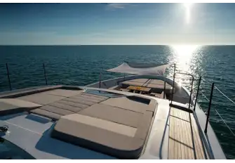 The large sunpad is accessible from the sun deck and a walkway on the main deck's starboard side leads to the foredeck lounge