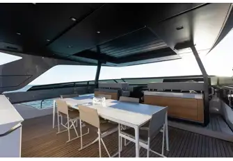 The sun deck has a flybridge forward and dining beneath the hardtop's louvred sunroof