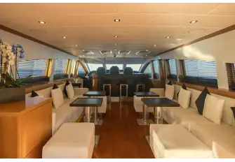 Looking forward towards the sit-up bar and bridge. Steps to the lower deck accommodation are to starboard of the bar