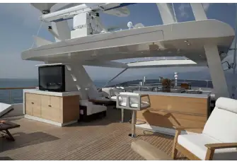 Looking forward from the sun deck sun lounge showing the rotating pop-up TV, sit-up bar and lounge