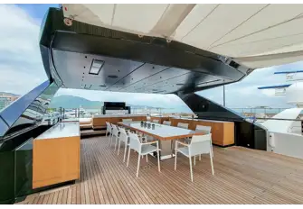 Sun deck dining beneath the hardtop, with extensive sun lounging space aft