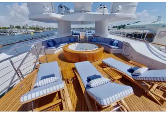 An expansive sun deck has a jacuzzi, sunbathing and lounge seating areas