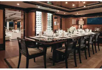 The main deck's formal dining area with wine cellar, forward of the main saloon