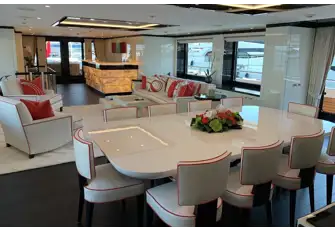 Looking aft in the main saloon with the port balcony's teak decking just visible in the right of shot