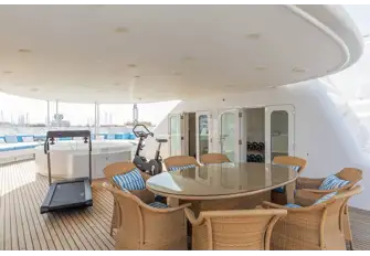 Foward there is seating, a jacuzzi, dining table, dayhead and jacuzzi equipment