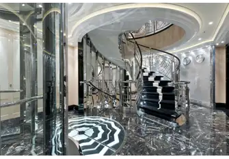 The steel and glass elevators, marble and rivetted aluminium staircase evoke the optimism of a new industrial age