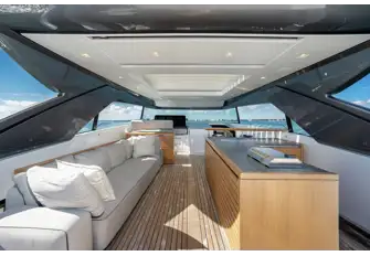 Beneath the hardtop with sun roof is a wet bar, buffet bar for open-air dining and a flybridge helm station