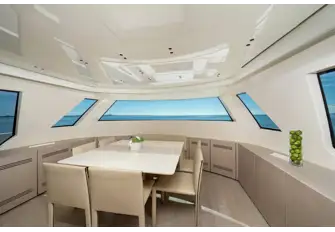 Forward on the main deck is a family galley and a formal dining room with wraparound views