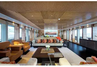 The main saloon has full-height windows, restful earth tones and pops of colour