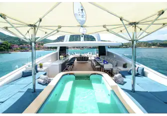 A huge sun deck has a bar, BBQ, dining, lounging, sun and shade as required, and a 10-person pool