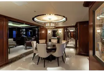 Forward of the main deck cinema room is a formal dining room and a library with an electric fireplace
