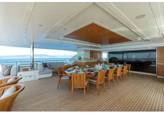 Open-air dining with bar and sun lounge on the upper deck aft