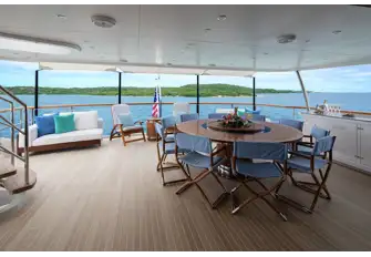 Open-air dining and sun lounging on the bridge deck aft