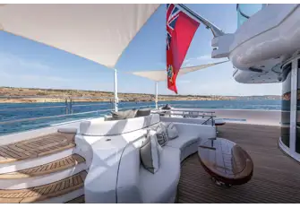 Seating, sunpads and steps to the beach club on the main deck aft