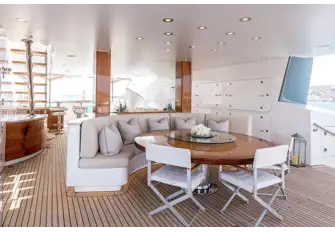 TALISMAN C - Looking forward from the sun lounge aft past the dining table, bar and daybed to the jacuzzi forward