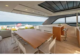 The bar and dining area's sunroof delivers light or shade as required. There is plenty of versatile deck space aft and a flybridge out of shot to the right
