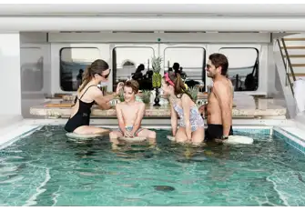 A sun deck pool with a swim-up bar