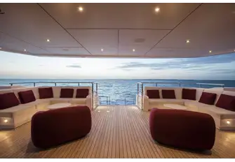 Banquette seating on the main deck aft with steps leading down to the swim platform