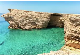 Stunning waters surround the Ksylobatis Caves on Ano Koufonisi in the southern Cyclades