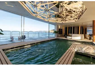 A 50sqm sea terrace outside a 30sqm counter flow pool, with a bottom that rises to become a dancefloor