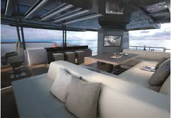 Just after of the flybridge helm station is a bar, dining and dayhead