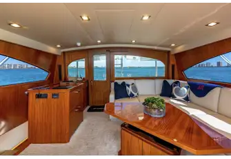 Aft of the enclosed bridge lounge there is lounge seating and a helm station
