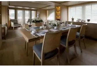 The dining area with the main saloon beyond and open-air dining on the aft deck