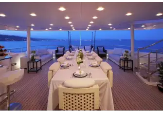 Open-air dining and a bar on the bridge deck aft