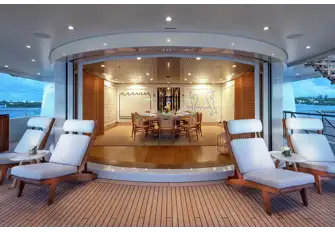 An indoor/outdoor circular dining room on the upper deck aft