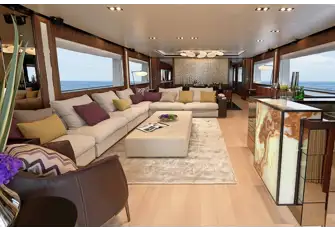 Full-height sliding glass doors open into the main saloon