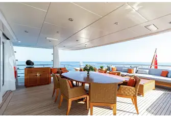 Open-air dining and a sun lounge on the bridge deck aft