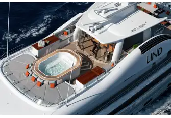 Sunpads, jacuzzi and a gym with sliding glass doors forward