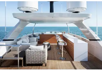 The sun deck with jacuzzi and sunpads forward, bar and lounge diner, with sun lounging deck aft
